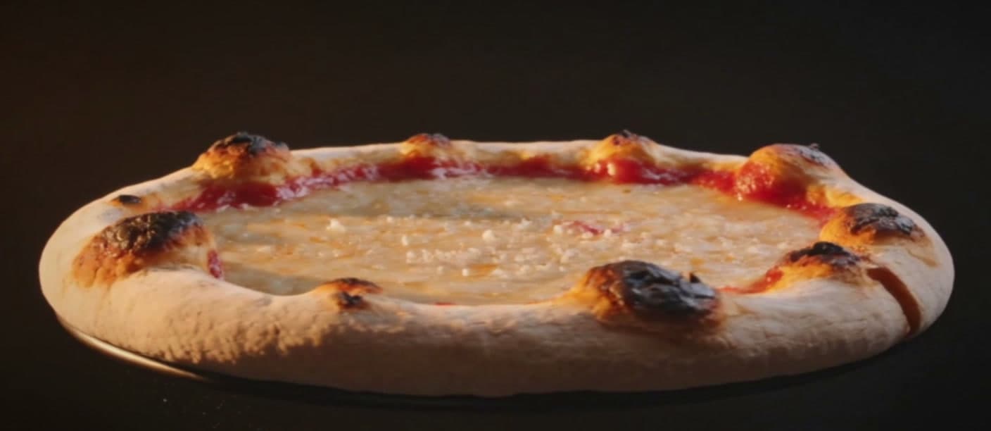A Forno Nero pizza glowing under warm restaurant light